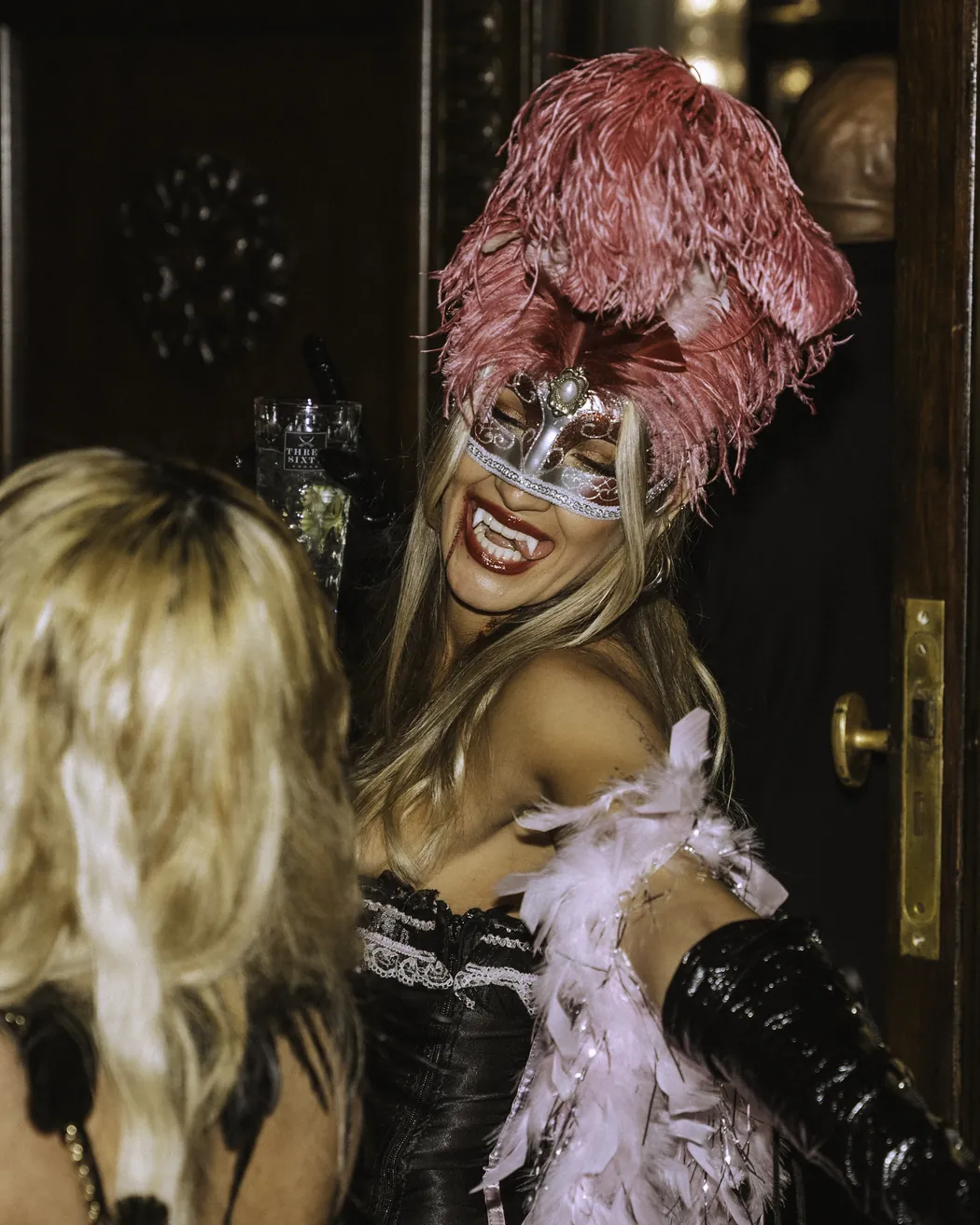 Gästin mit rosa Federmaske